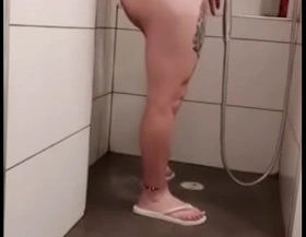 � Karen shows us her red toes white flip flops while showering